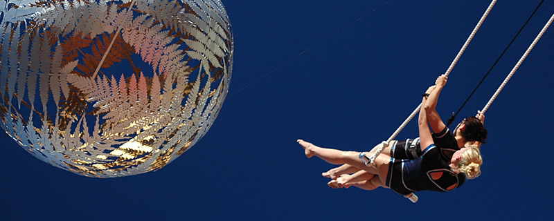 Laura and Rowan on swinging trapeze in Civic Square Wellington
