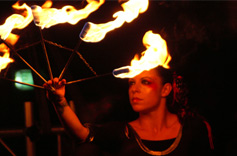 Laura holds a fire fan. 
